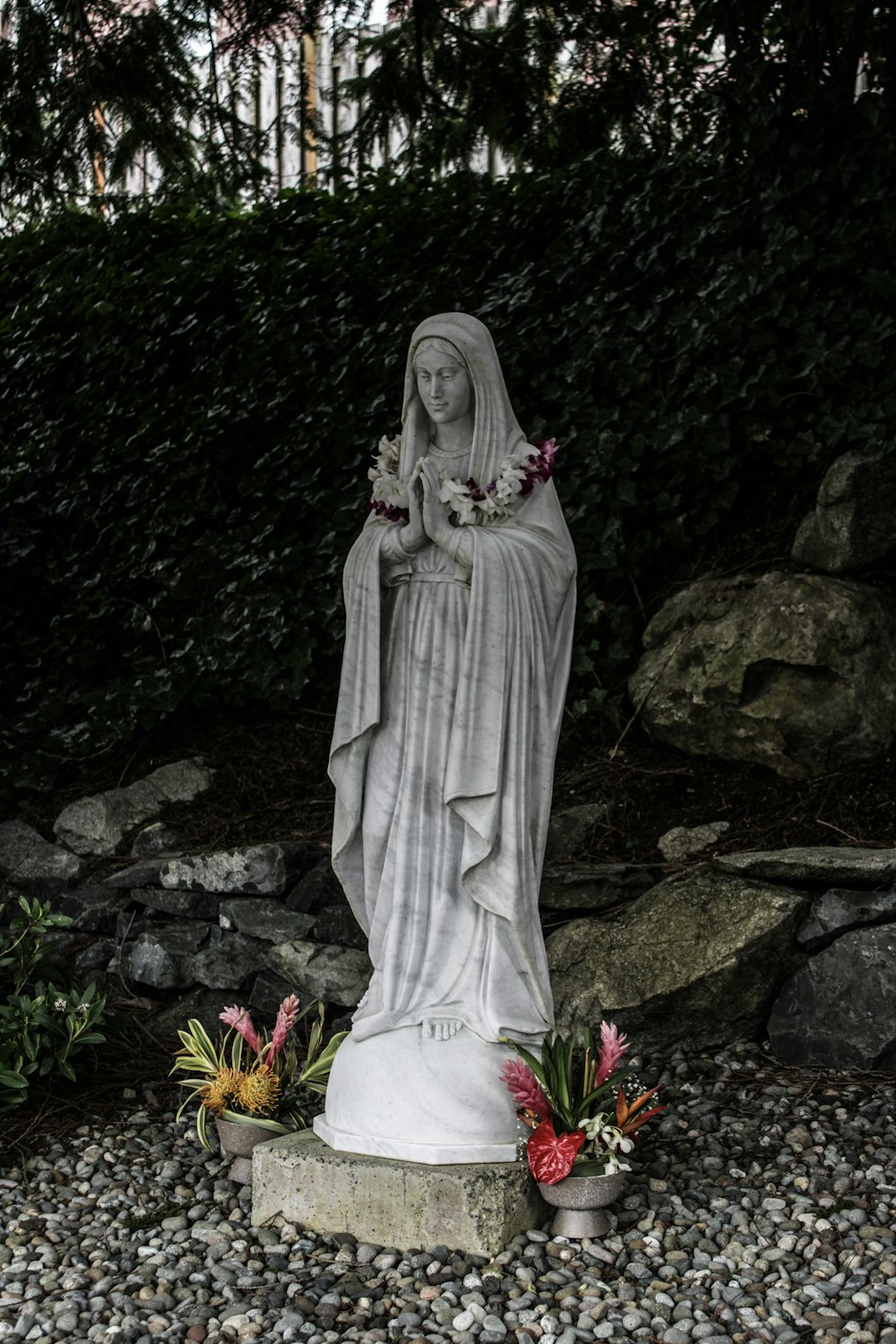 a statue of a woman with flowers in her hands