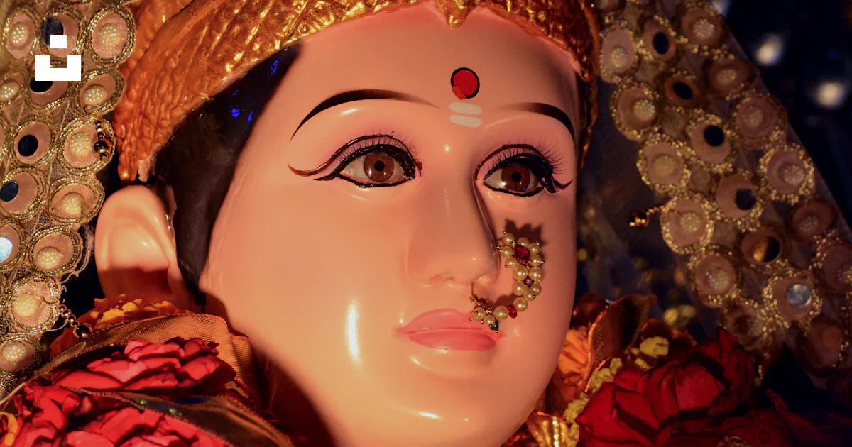 Devi Person A close up of a statue of a person wearing a headdress photo – Free ...