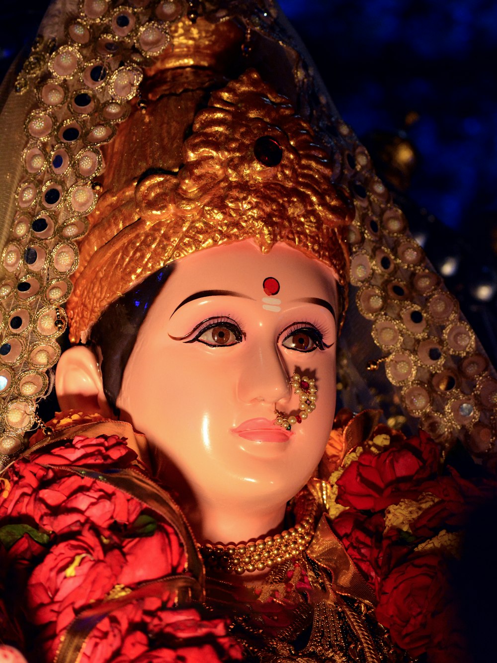 a close up of a statue of a person wearing a headdress