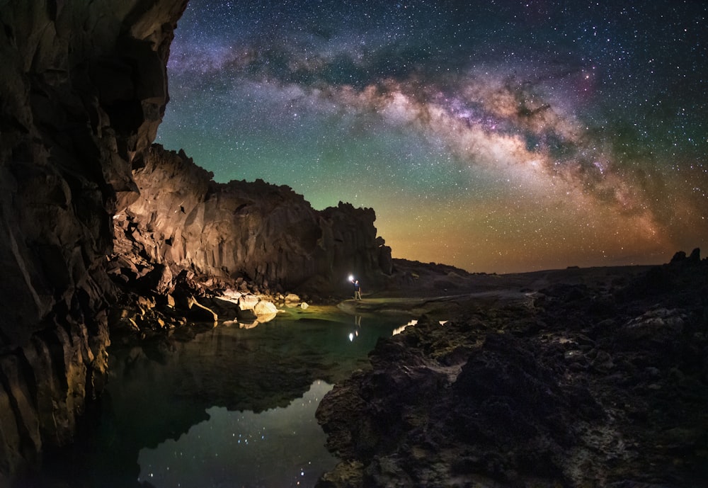 a view of the night sky from inside a cave