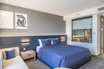 a bedroom with a bed and a couch in it