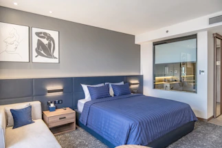 a bedroom with a bed and a couch in it