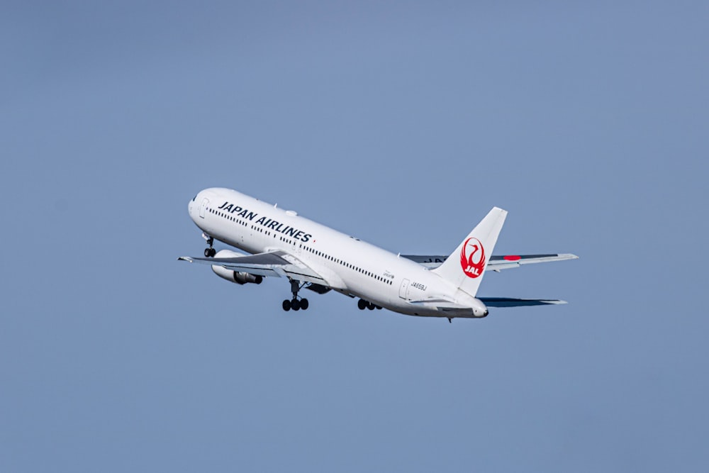 a large jetliner flying through a blue sky