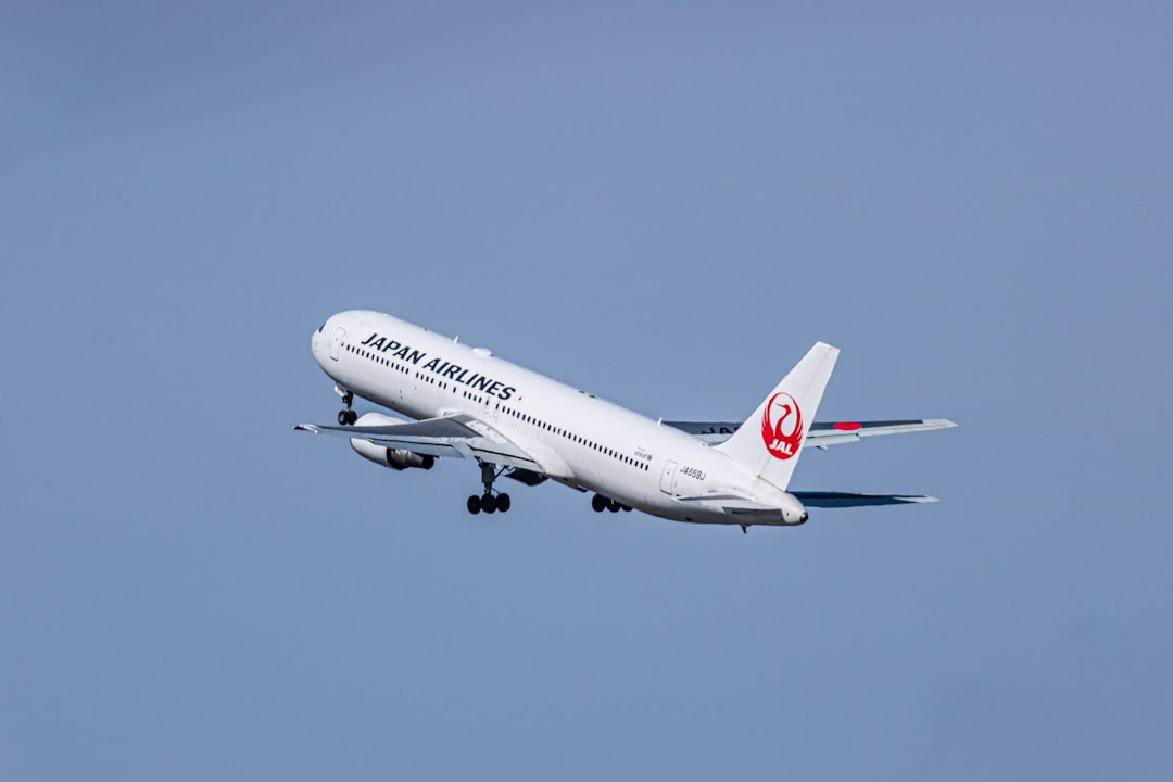 a large jetliner flying through a blue sky,