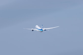 a large passenger jet flying through a blue sky