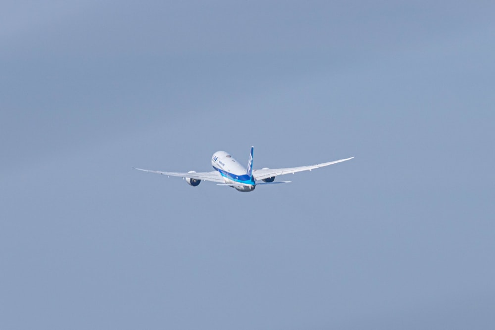 a large passenger jet flying through a blue sky