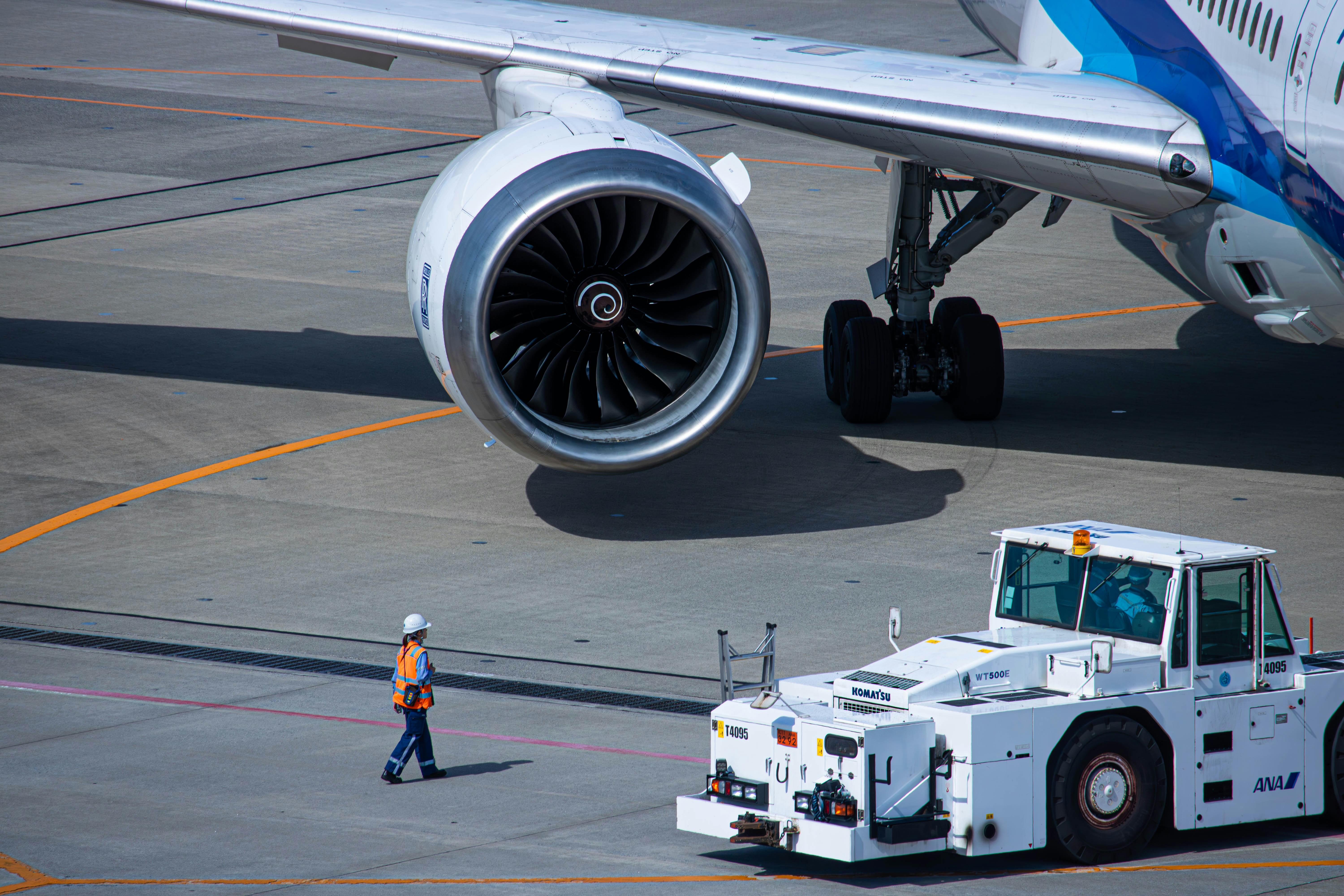 a large jetliner sitting on top of an airport tarmac, 