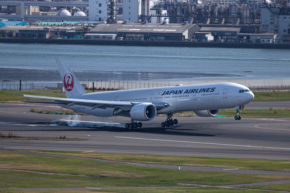 a japan airlines jet taking off from an airport runway