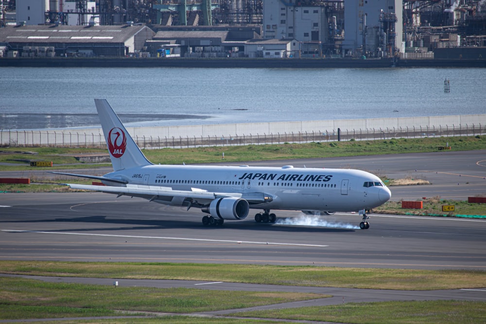 a japan airlines plane on the runway of an airport