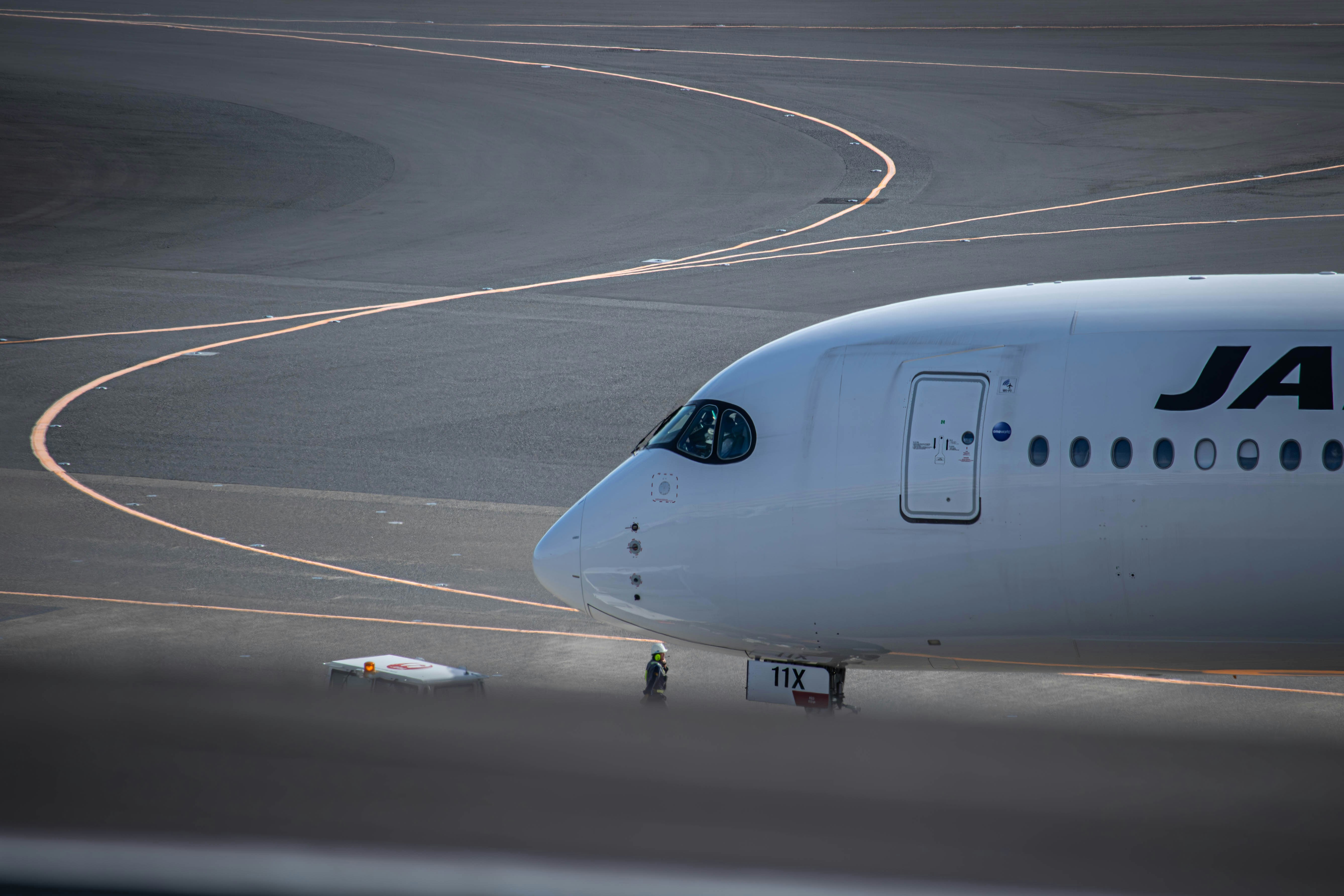 a large jetliner sitting on top of an airport runway, 