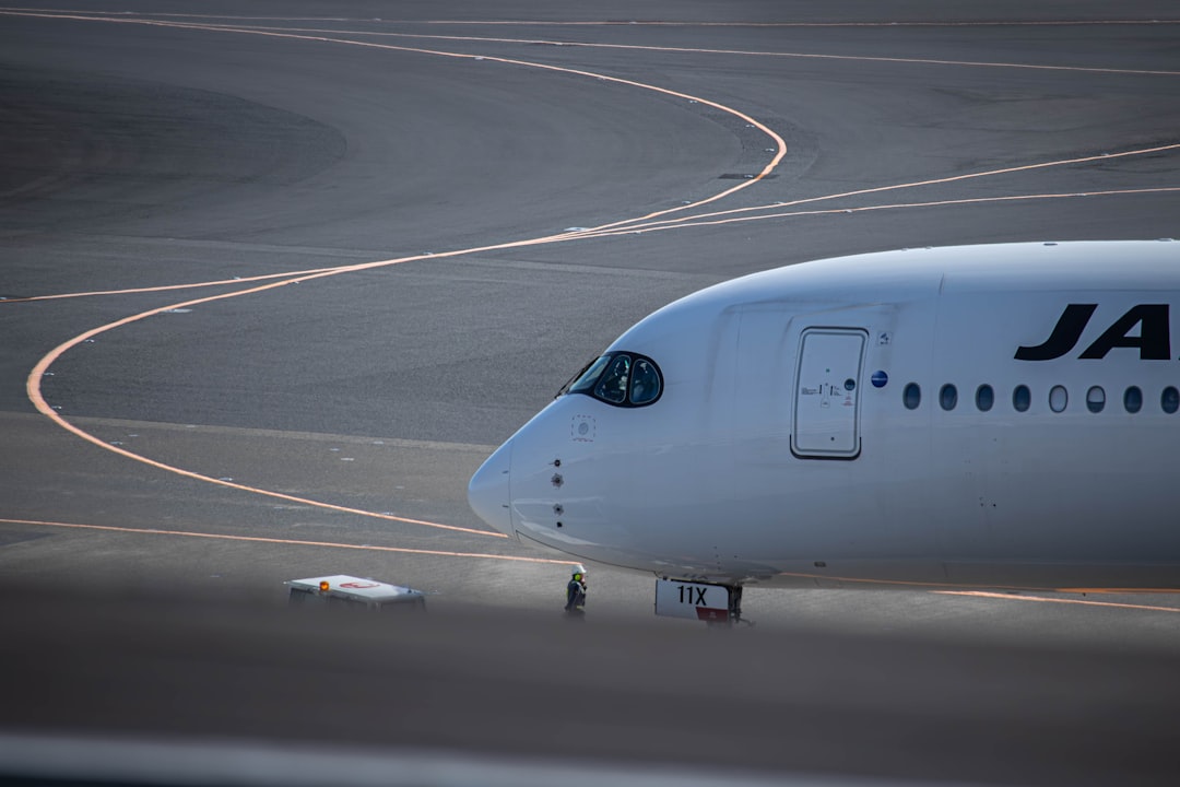 a large jetliner sitting on top of an airport runway,