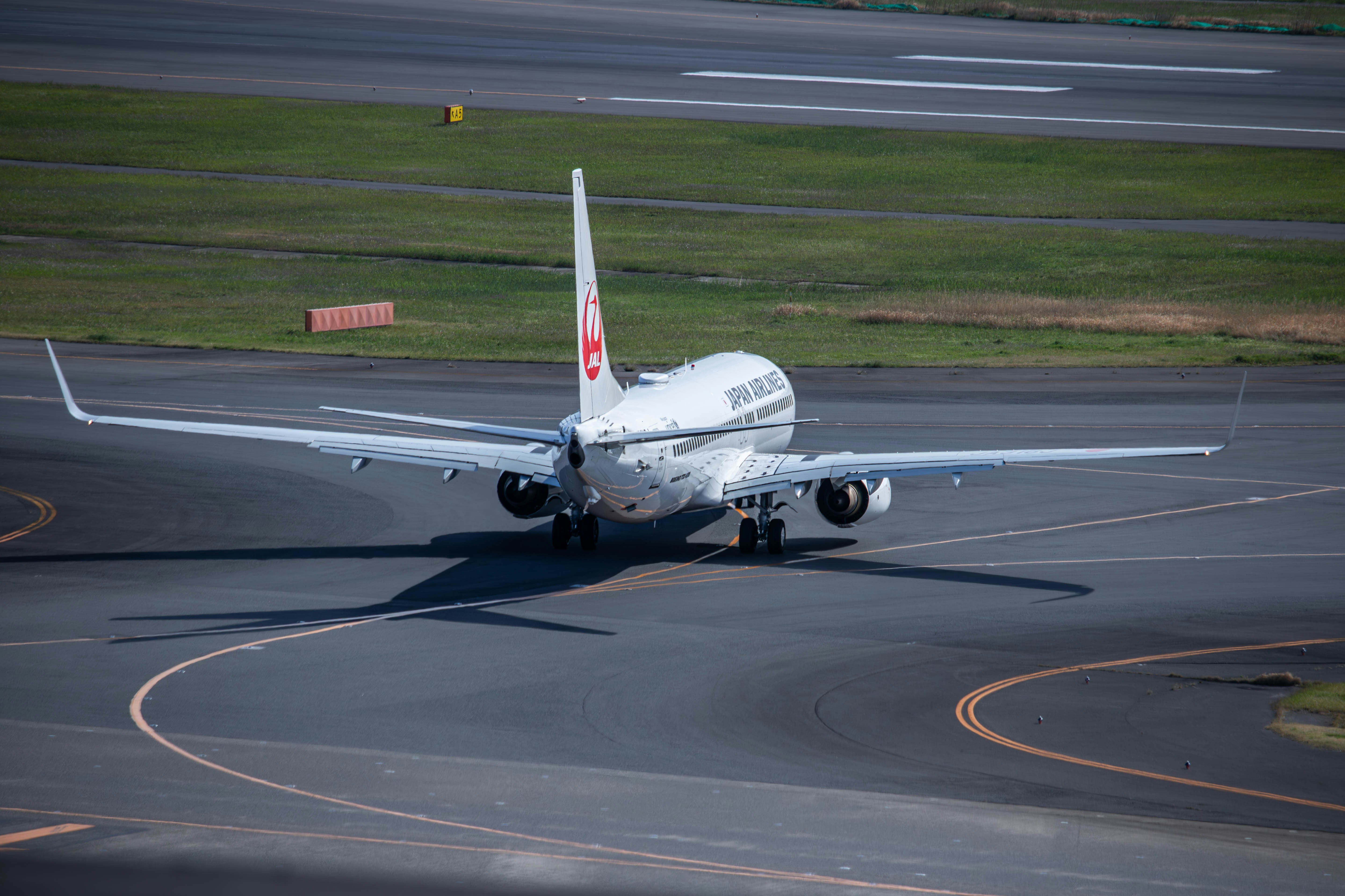 a large jetliner sitting on top of an airport runway, 