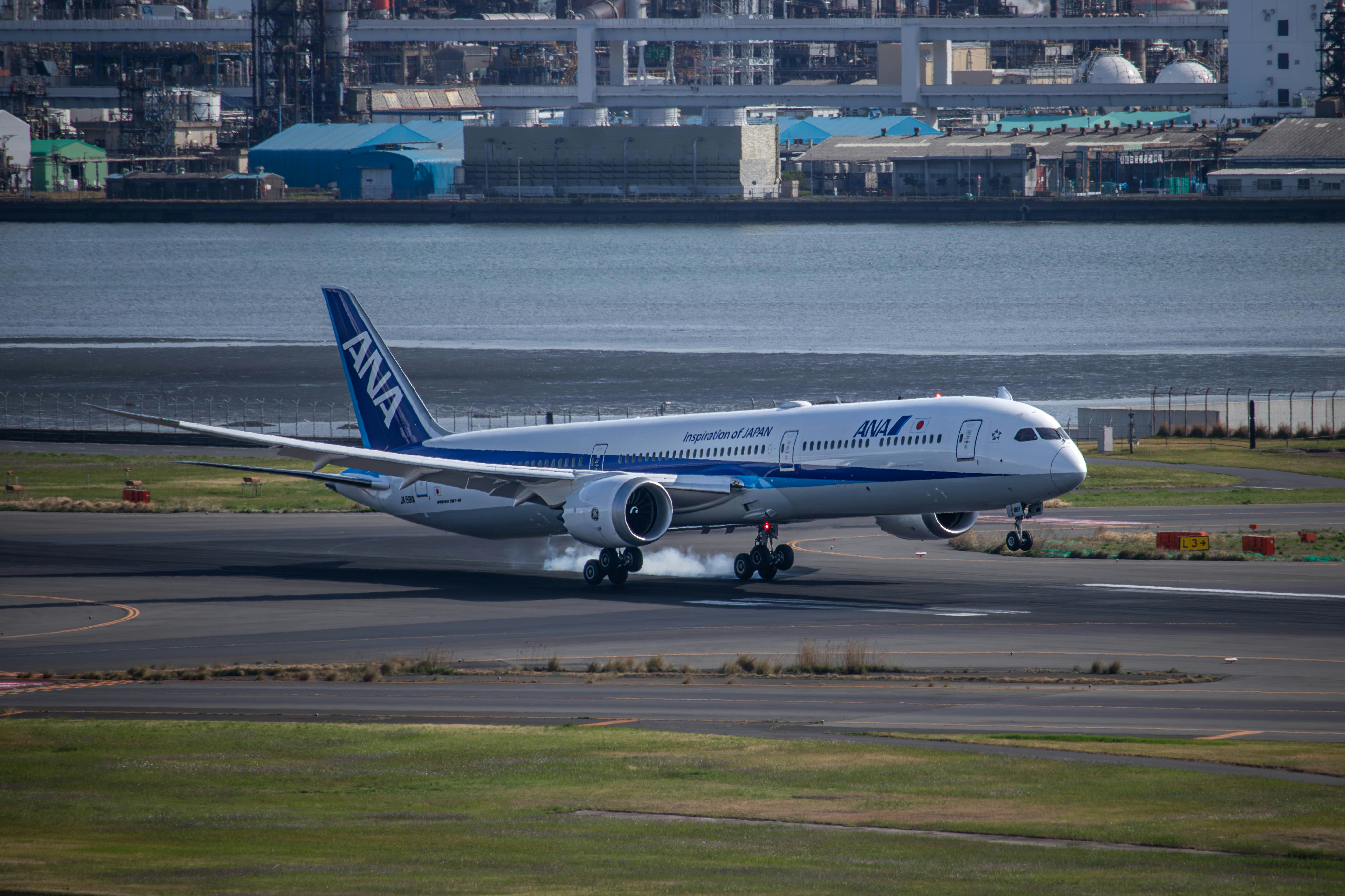 a large jetliner sitting on top of an airport runway, 