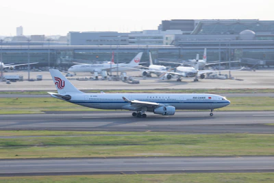 a large jetliner sitting on top of an airport runway