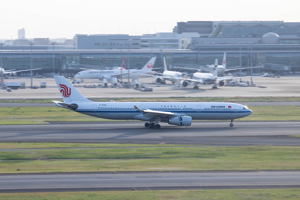 a large jetliner sitting on top of an airport runway