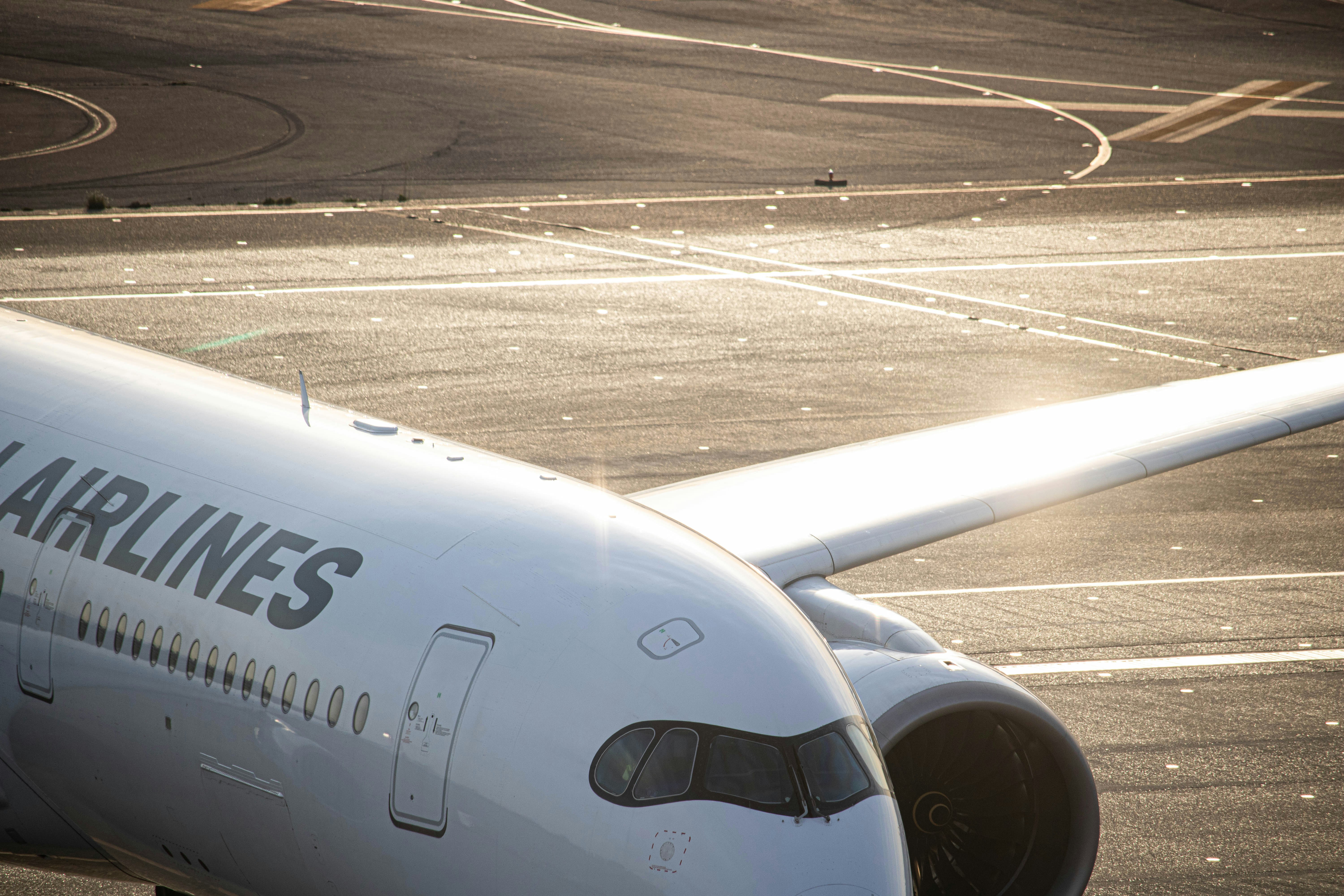 a large jetliner sitting on top of an airport tarmac, 