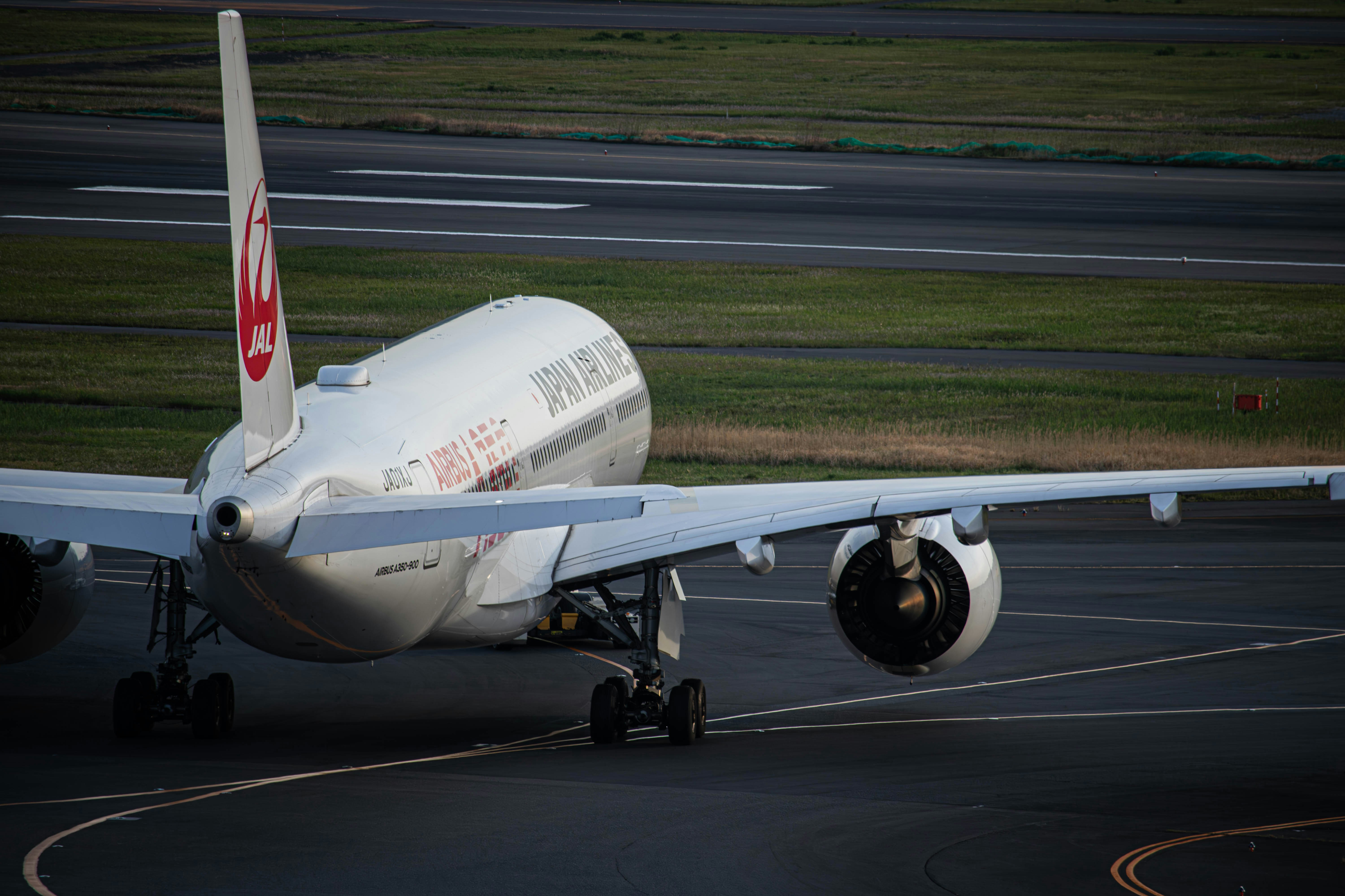 a large jetliner sitting on top of an airport runway, 