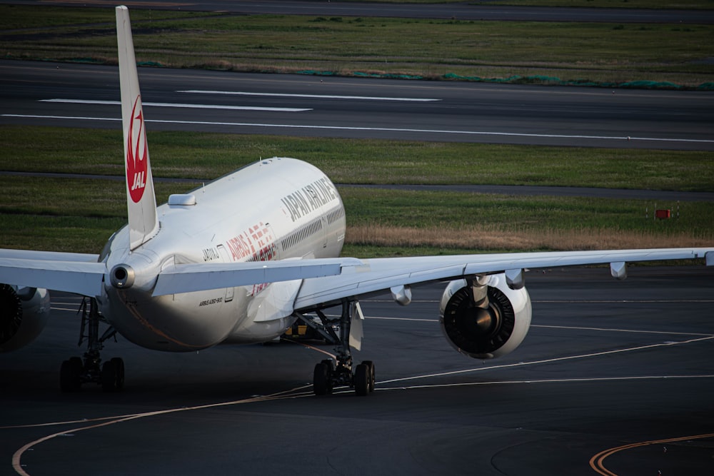 a large jetliner sitting on top of an airport runway