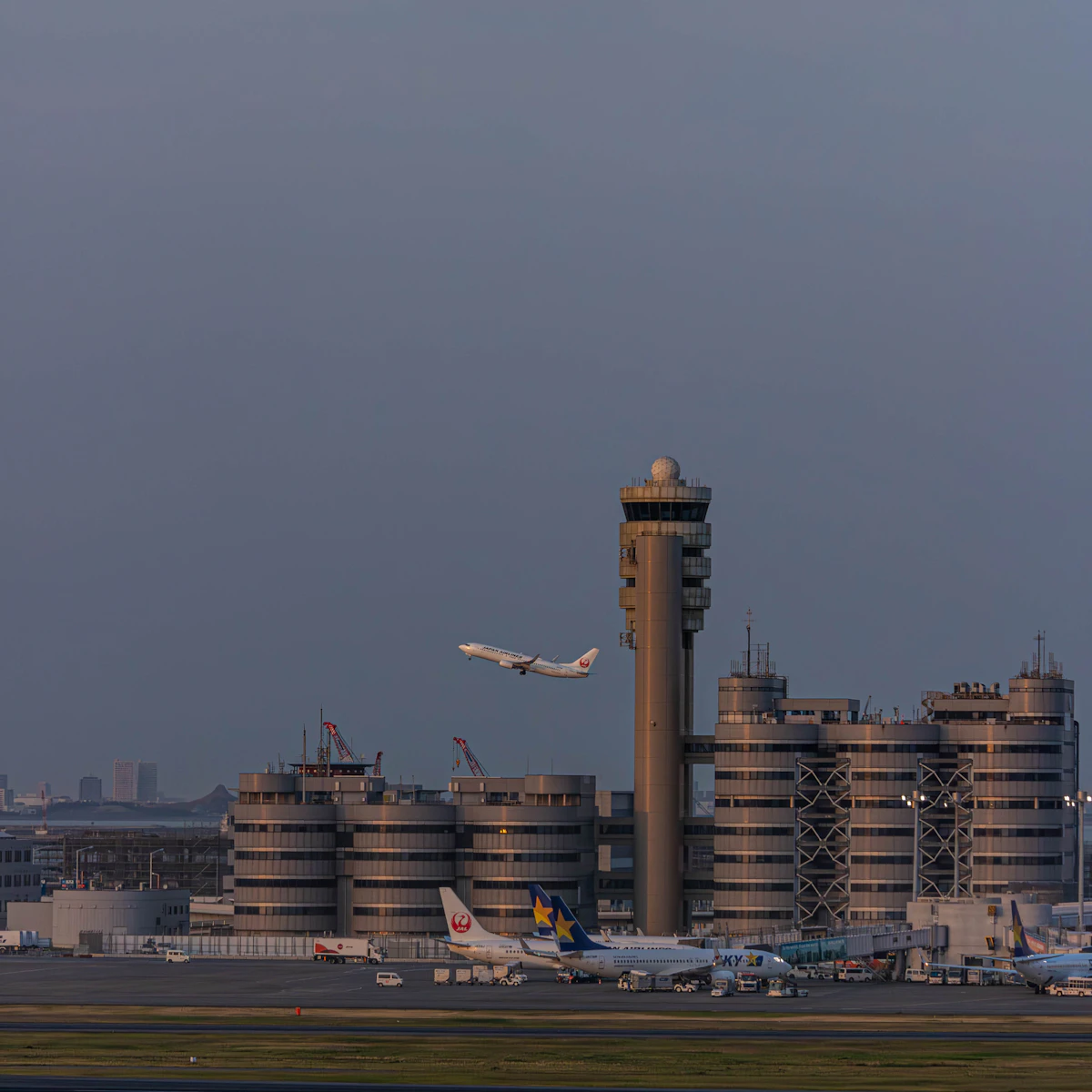An airport control tower beside a runway