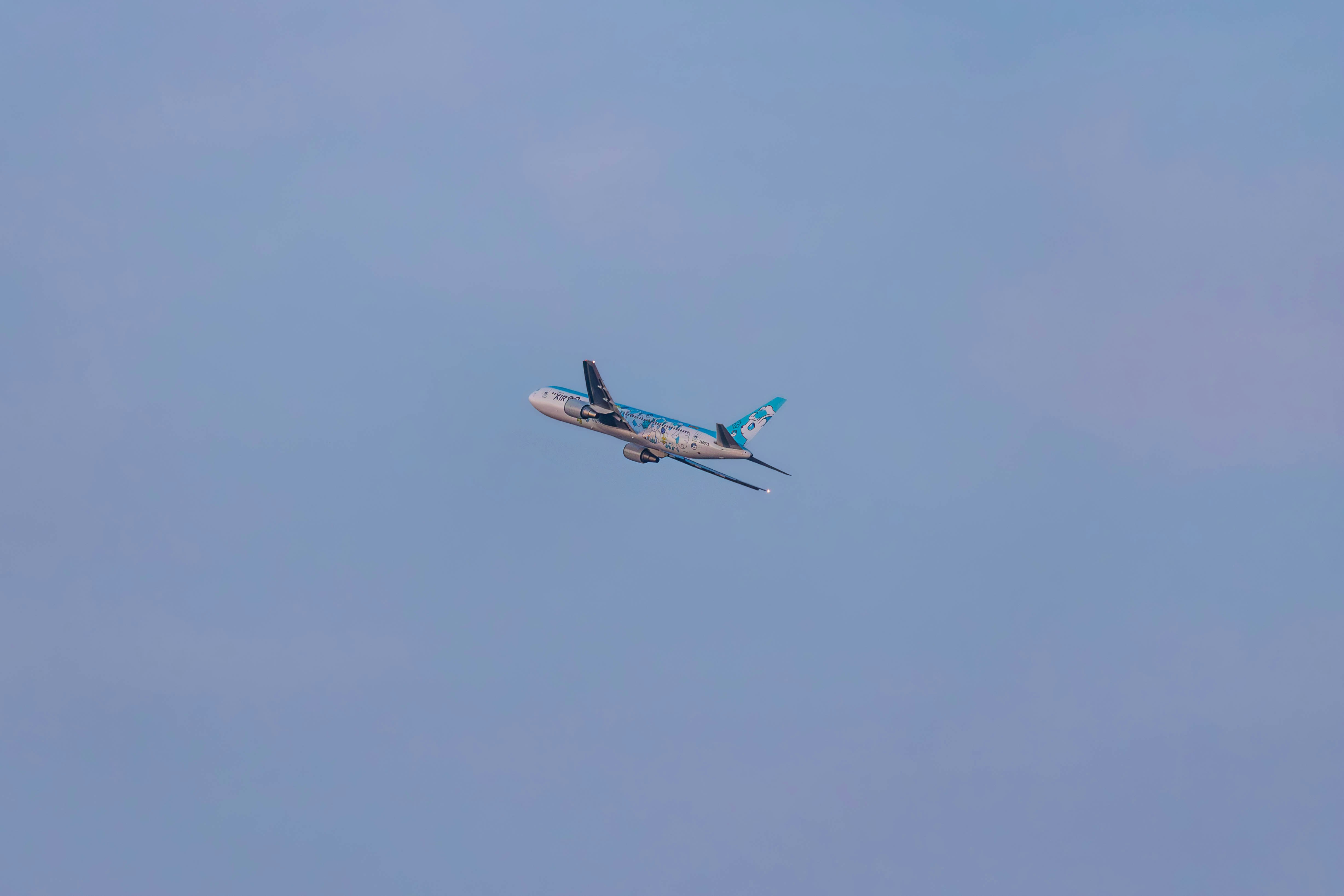 an airplane is flying in the sky on a clear day