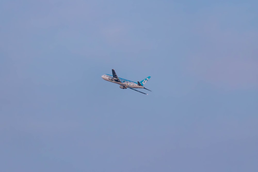 an airplane is flying in the sky on a clear day