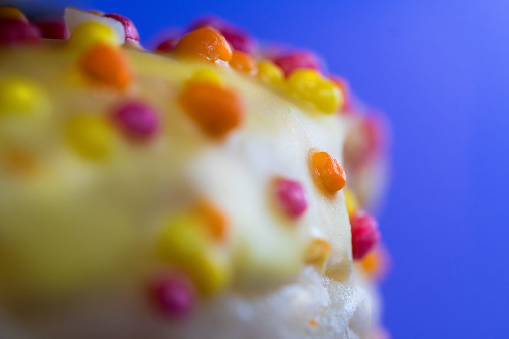 a close up of a cake with white frosting and colorful candies