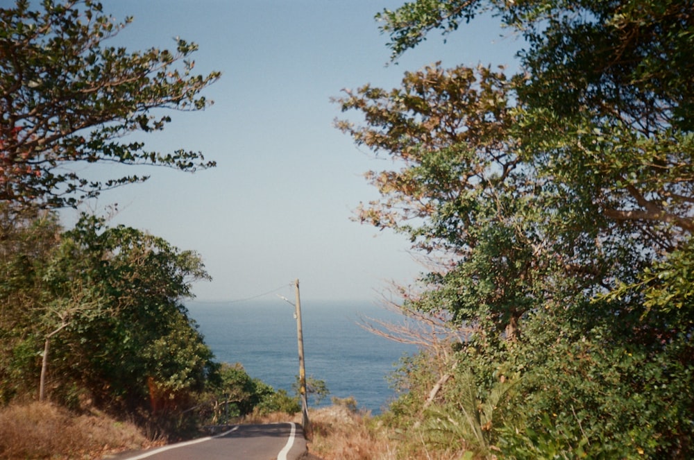 an empty road with a view of the ocean