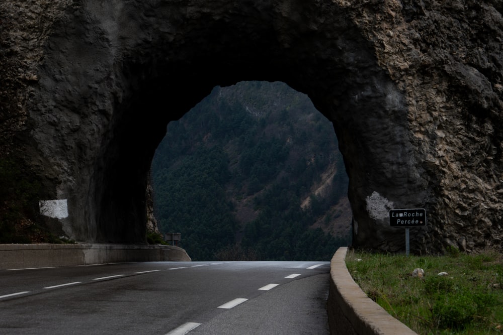 a car driving through a tunnel on a road