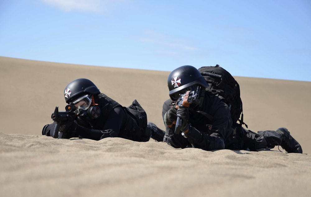 a couple of people that are laying in the sand