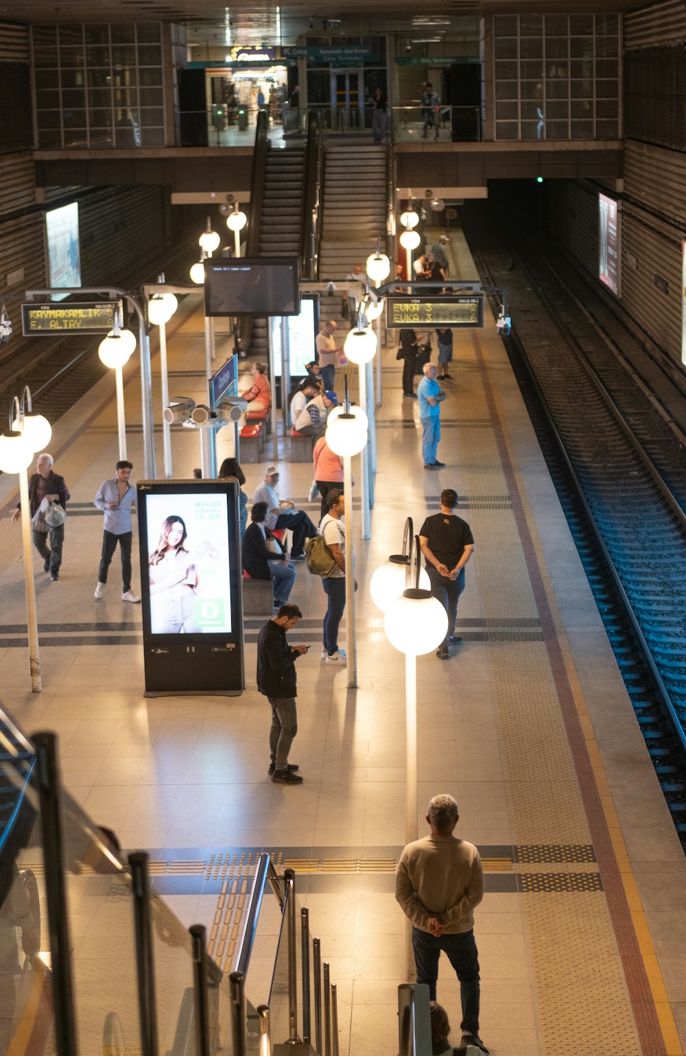 a group of people standing around a train station