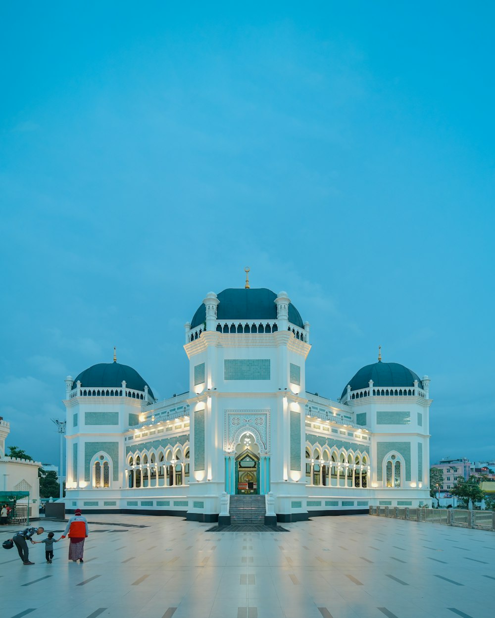 a large white building with a blue roof