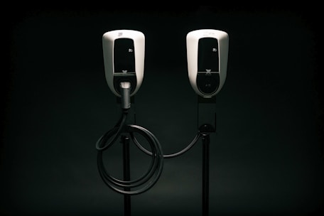 a couple of black and white phones on a black background