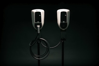 a couple of black and white phones on a black background