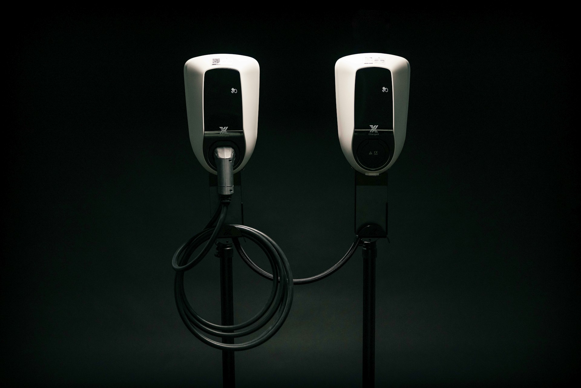 a couple of black and white phones on a black background