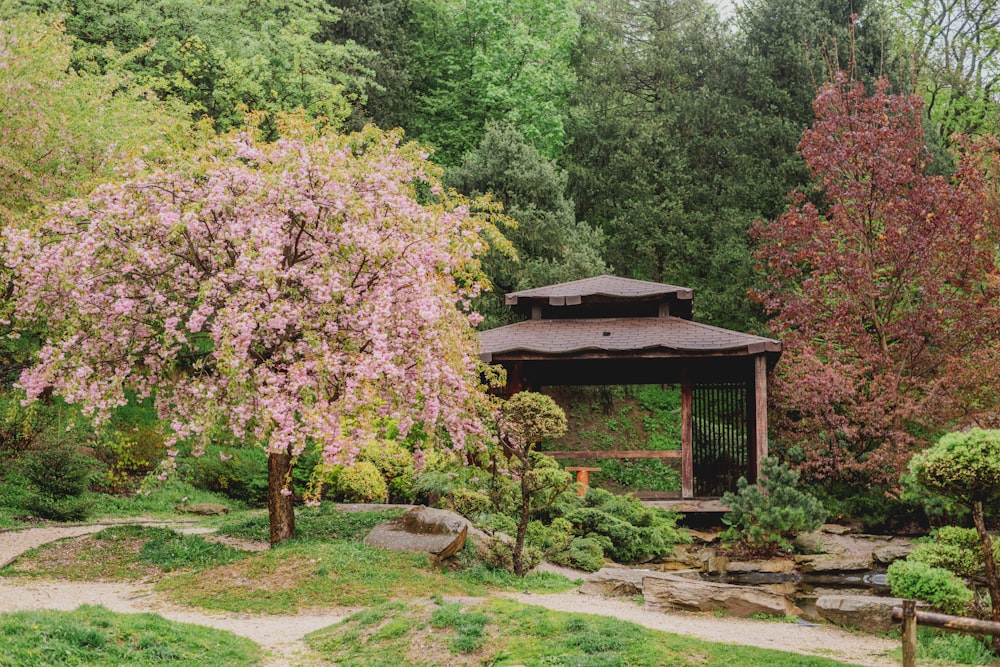 a gazebo in the middle of a lush green park