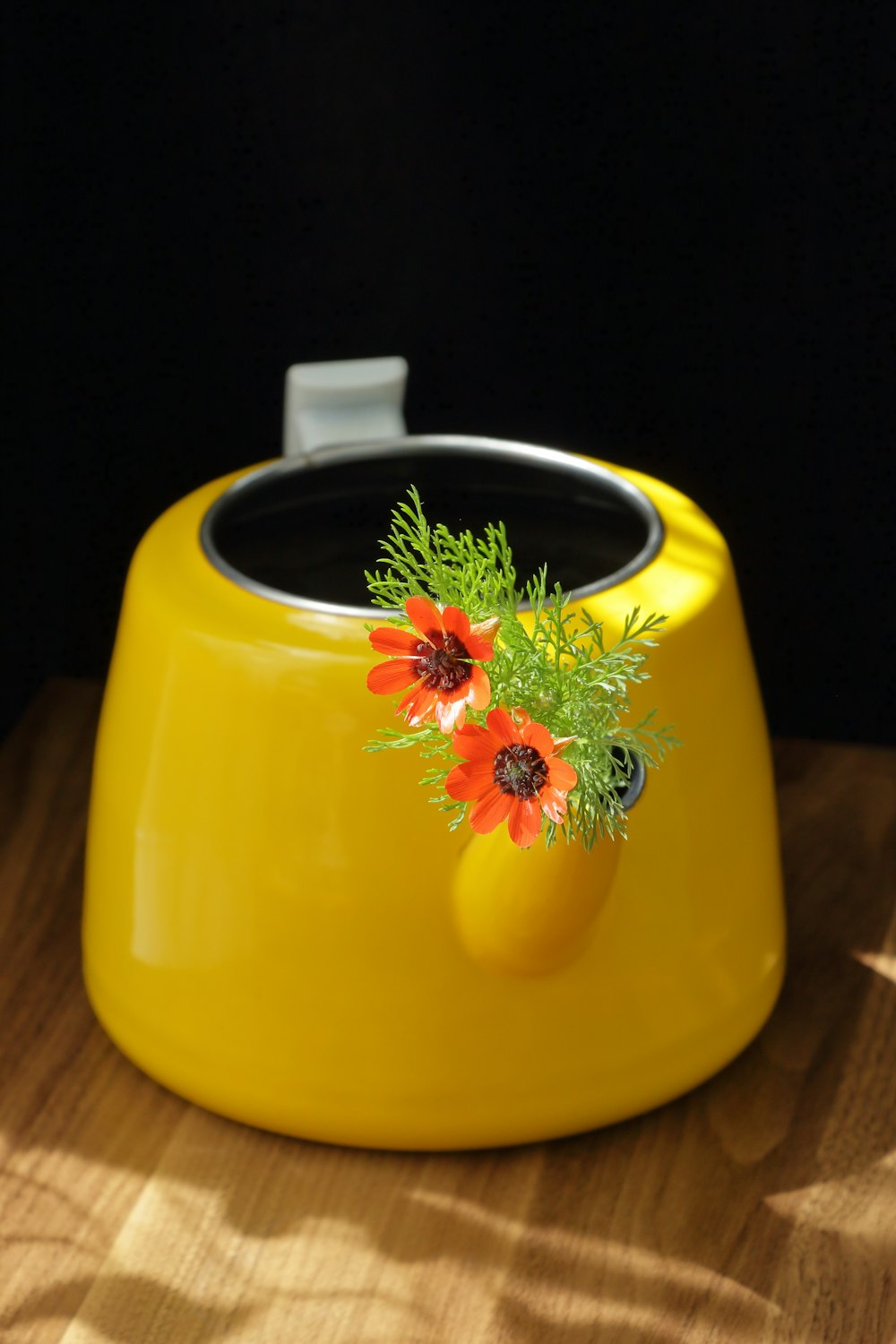 a yellow dog bowl with flowers on it