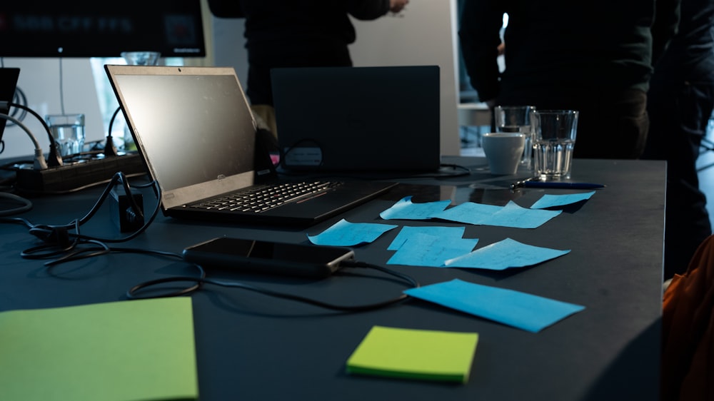 a table with sticky notes and a laptop on it