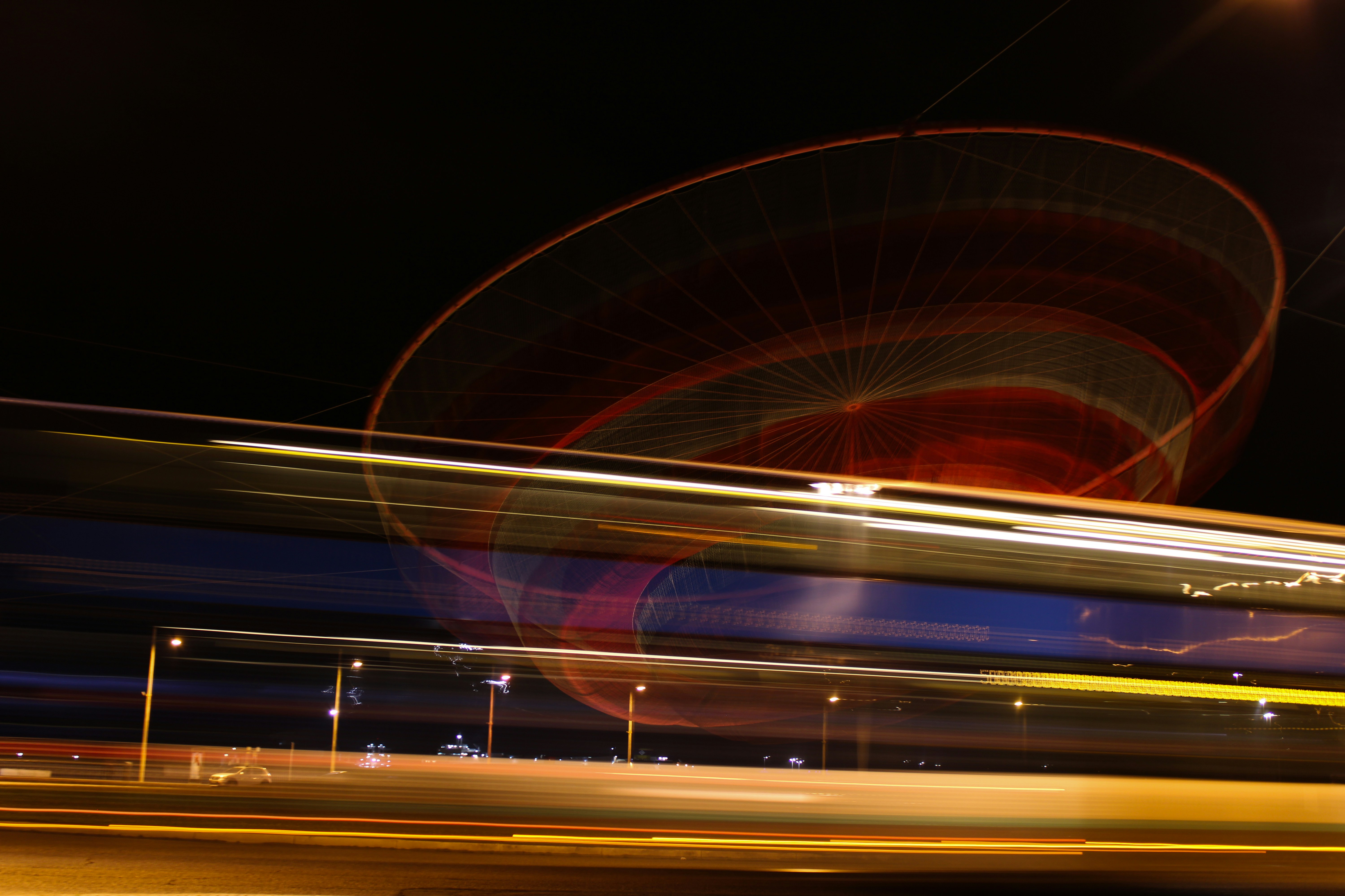 a blurry photo of a ferris wheel at night