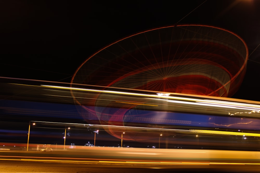 a blurry photo of a ferris wheel at night