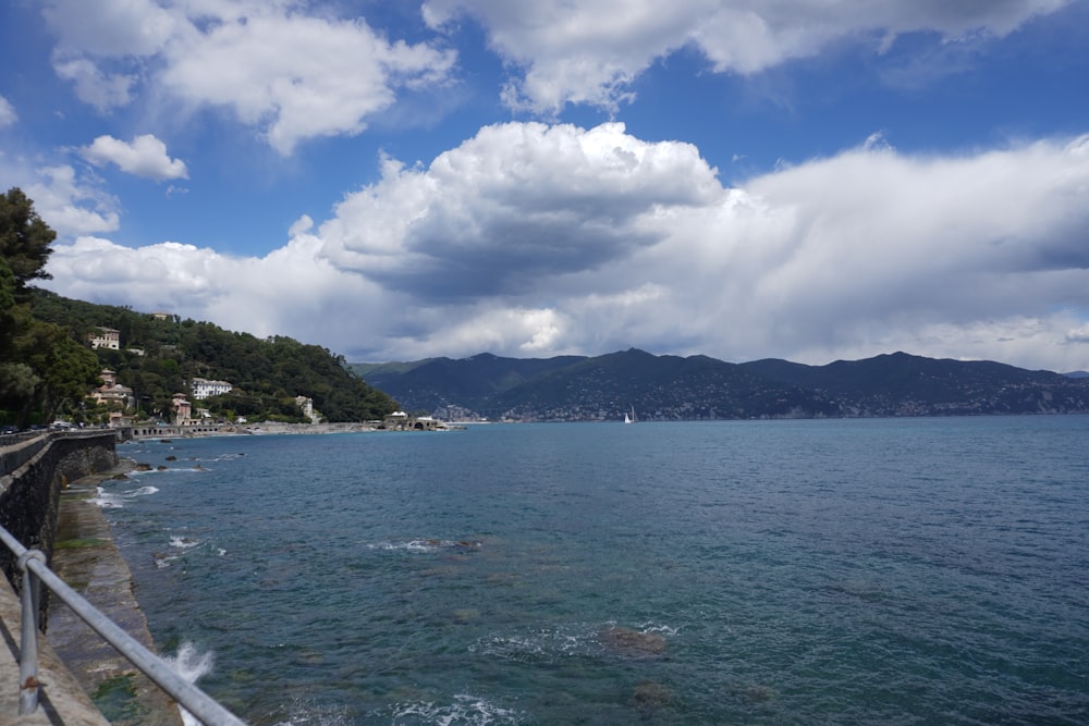 a large body of water with mountains in the background