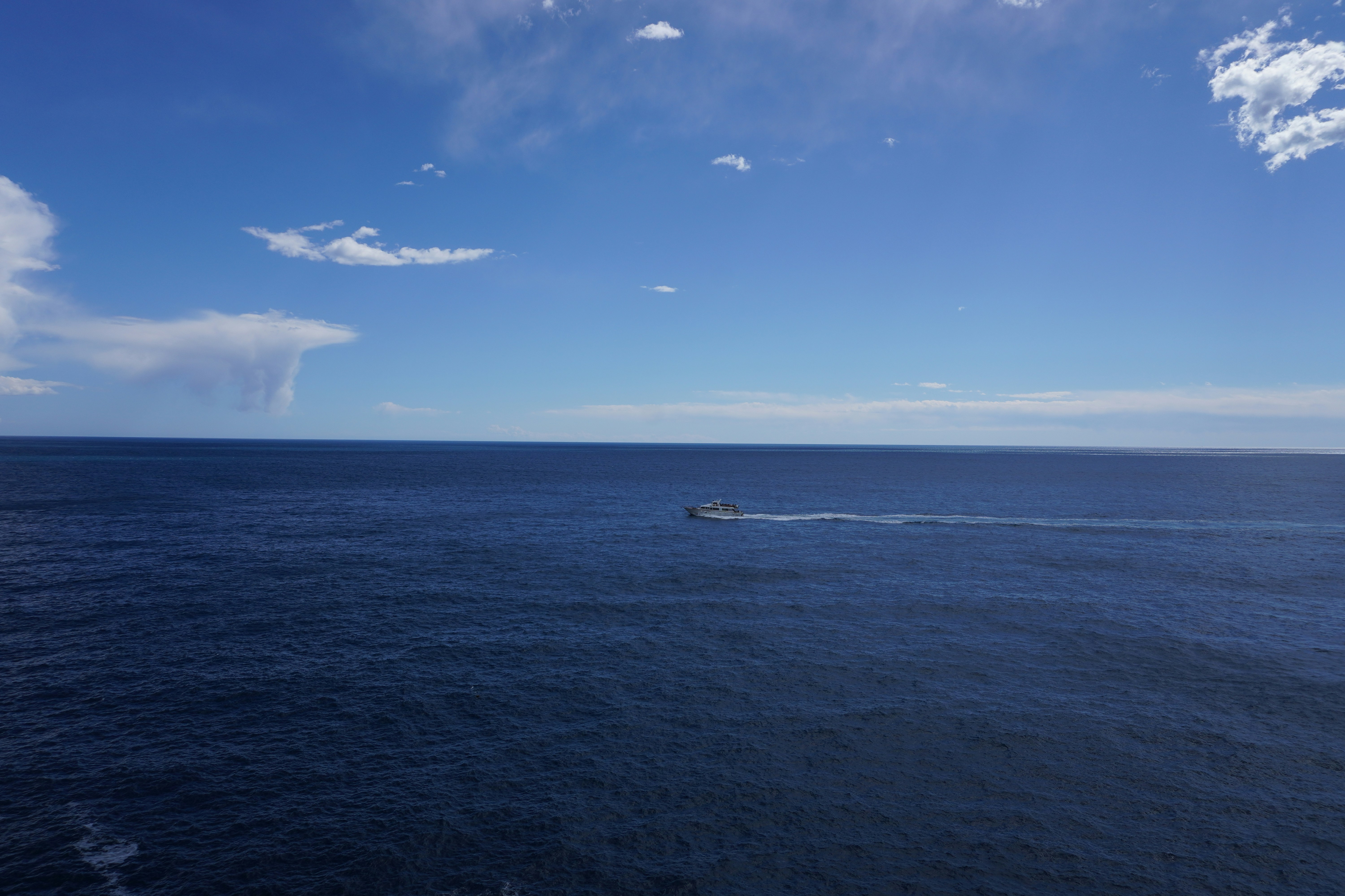 a small boat traveling across a large body of water