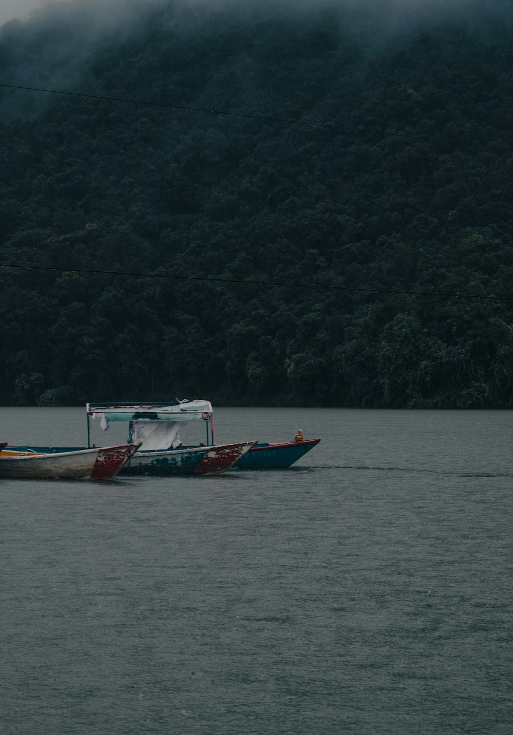 a small boat is floating on a large body of water