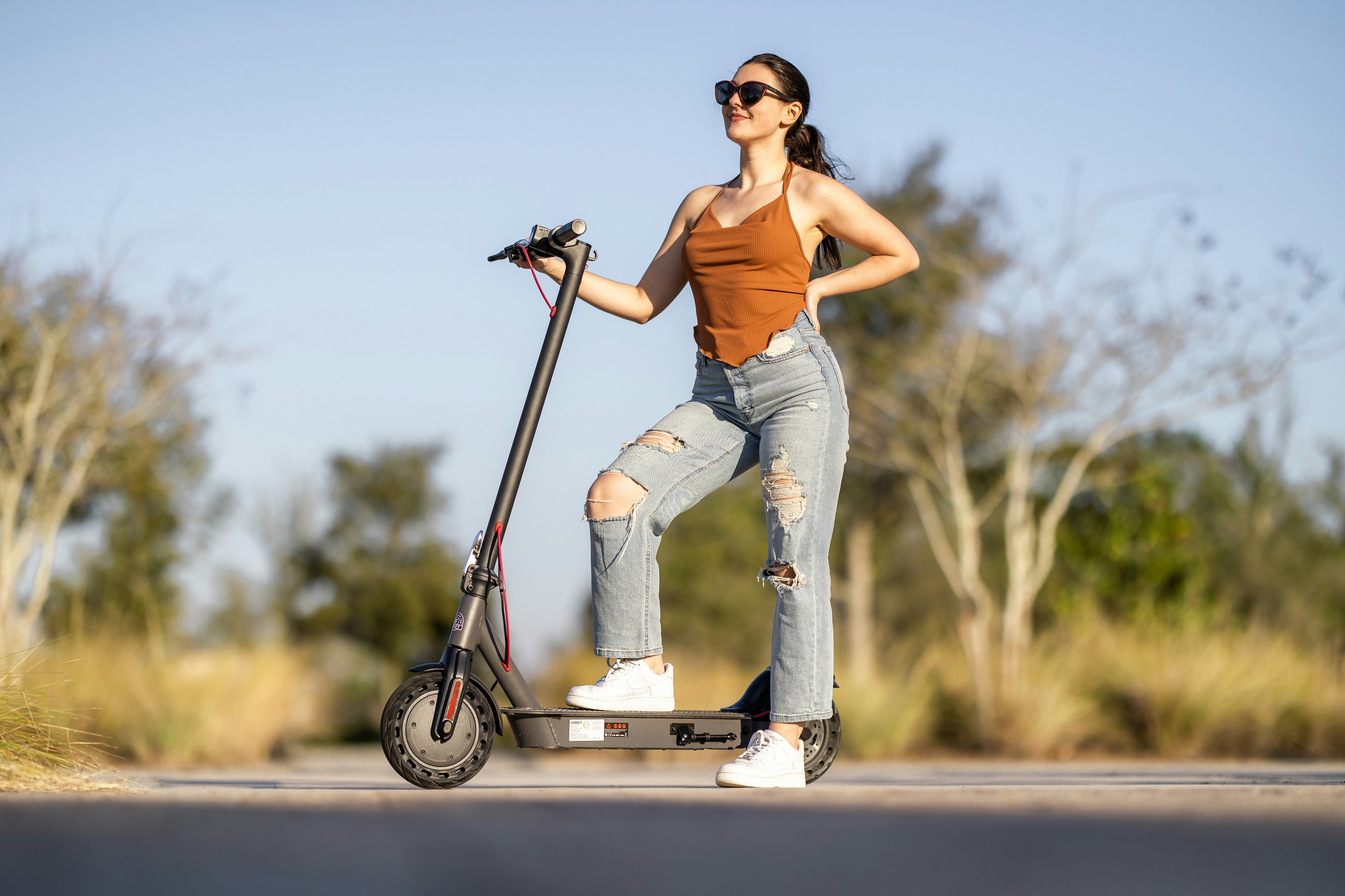 a woman riding a scooter on the road