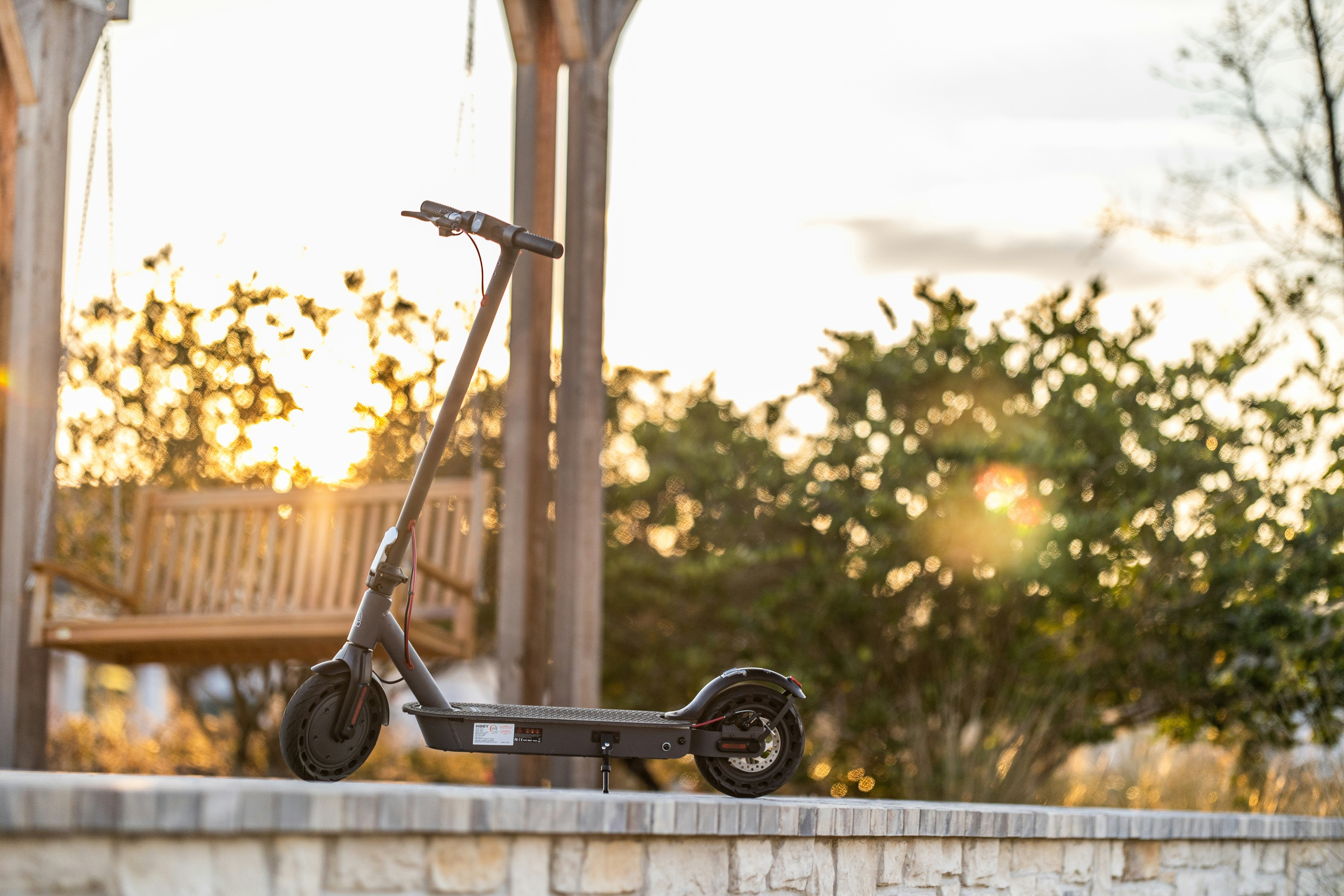 a scooter is parked on a brick wall