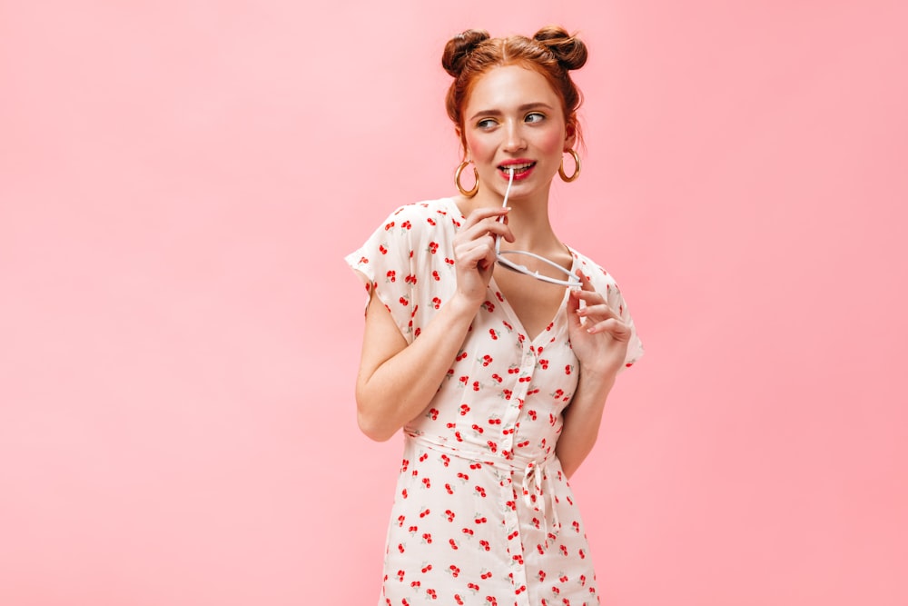 a woman in a white dress holding a toothbrush