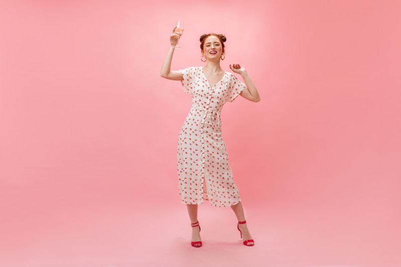 Refined woman in white dress with wine