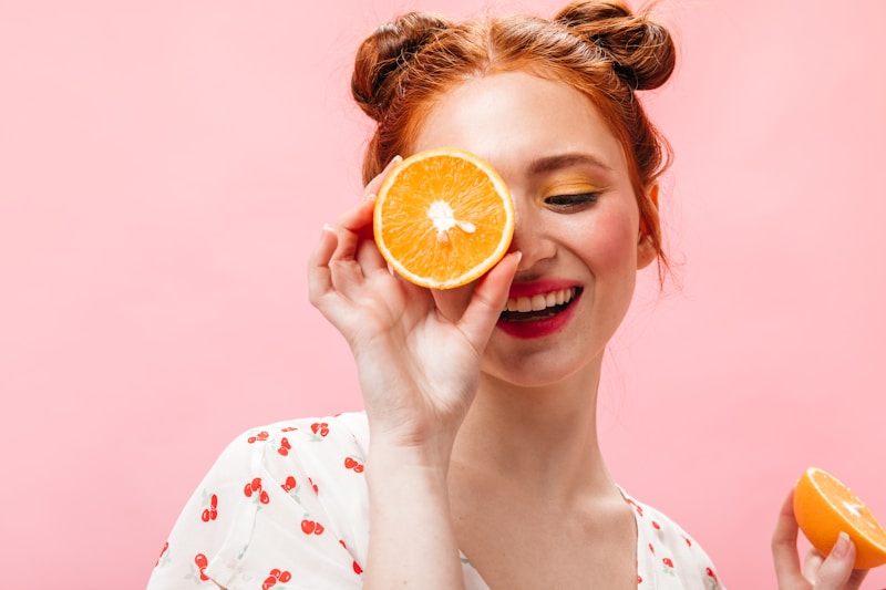 Elegant woman posing with orange