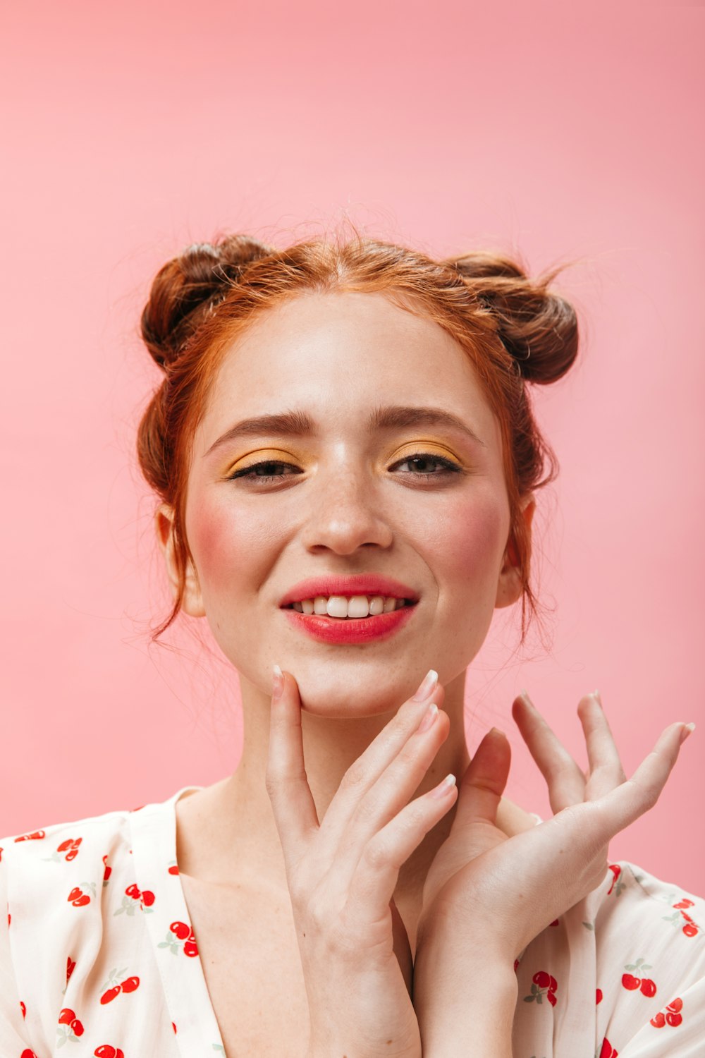 a woman posing with her hands on her face