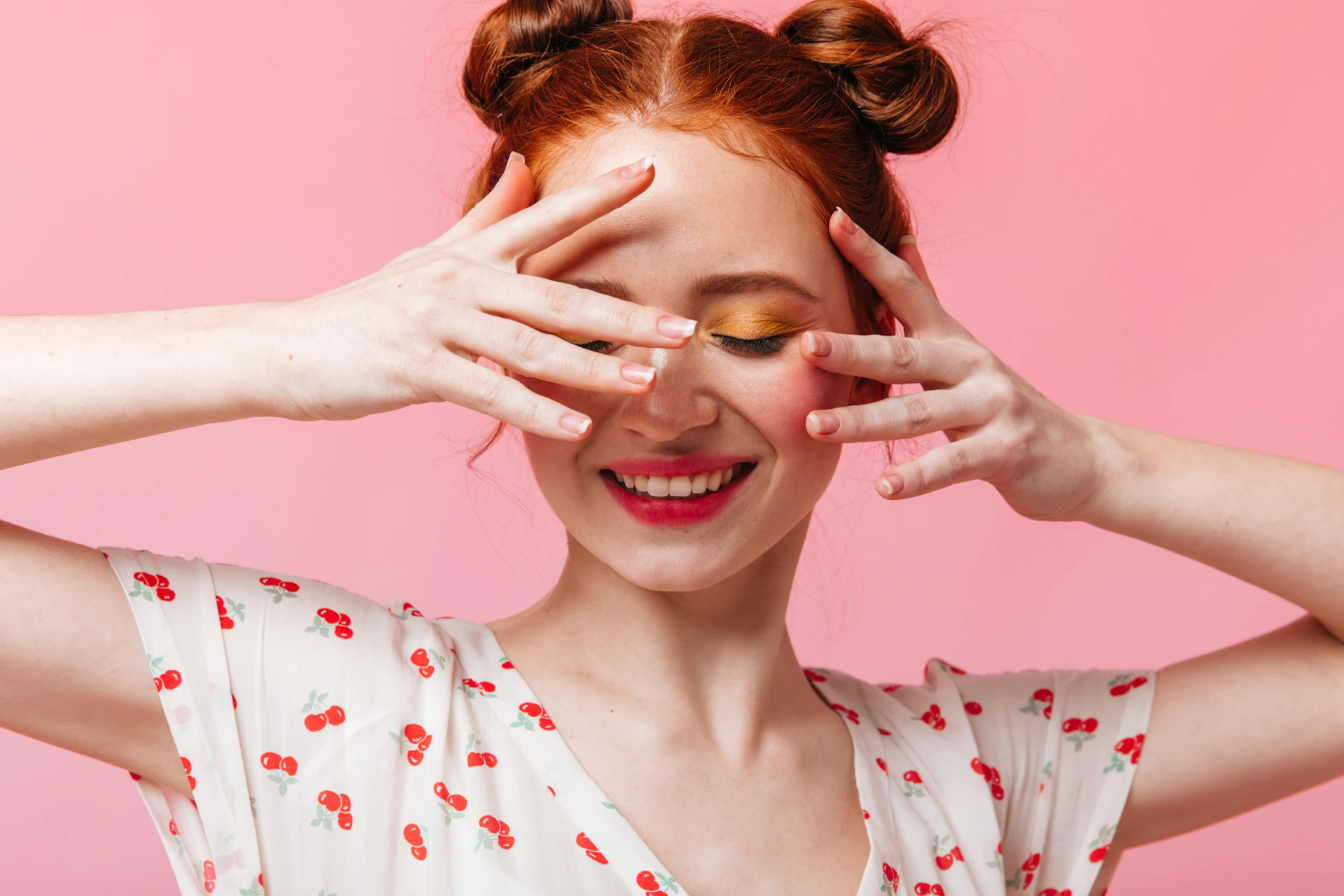 a woman holding her hands up to her face