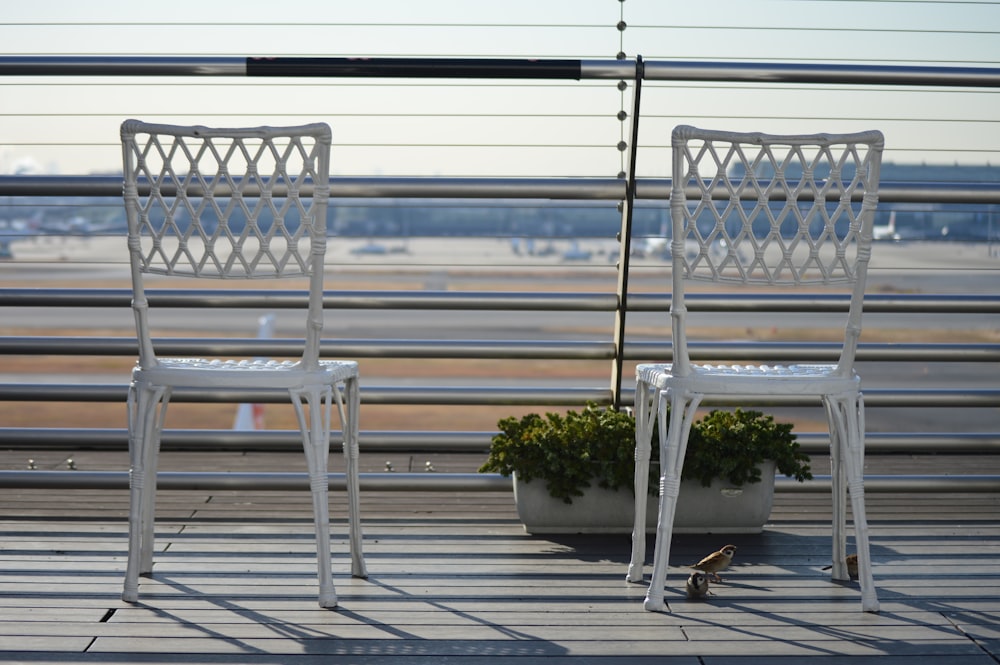 a couple of white chairs sitting next to each other